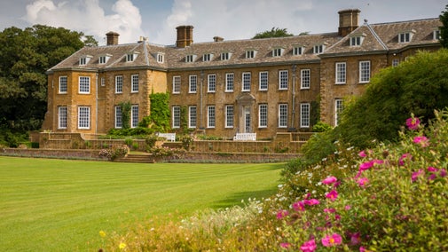 The south garden with balustraded terrace, and sweeping lawn at Upton House and Gardens, Warwickshire